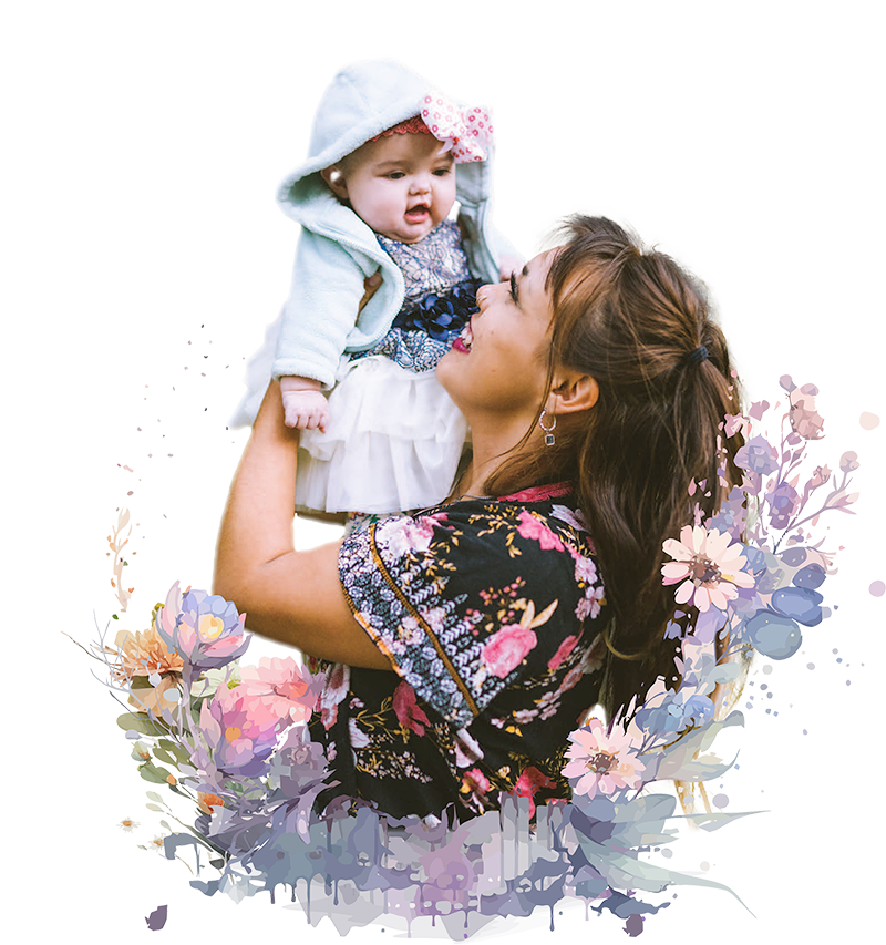 mother holding baby surrounded by flowers